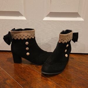 Elegant Black and Tan Heeled Boots with Button Accents